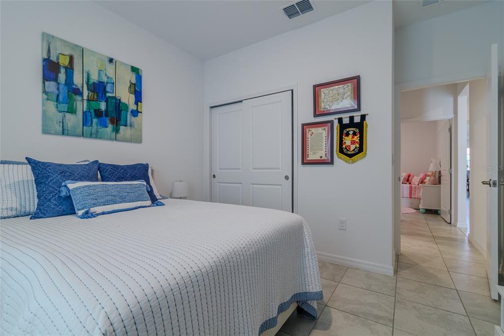 7095 Southwest 61st Place Ocala, FL 34474 - Photo 35 of 61 a bedroom with a bed and painting on the wall