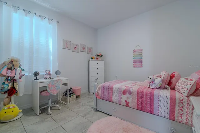 a bedroom with a bed and a television