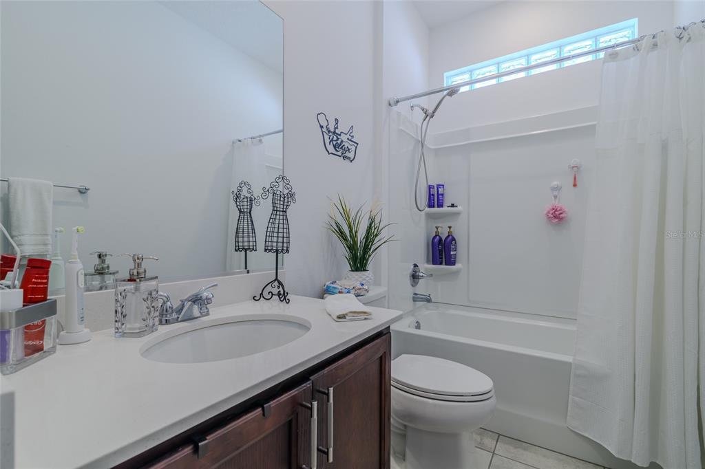 7095 Southwest 61st Place Ocala, FL 34474 - Photo 42 of 61 a bathroom with a sink vanity mirror and toilet
