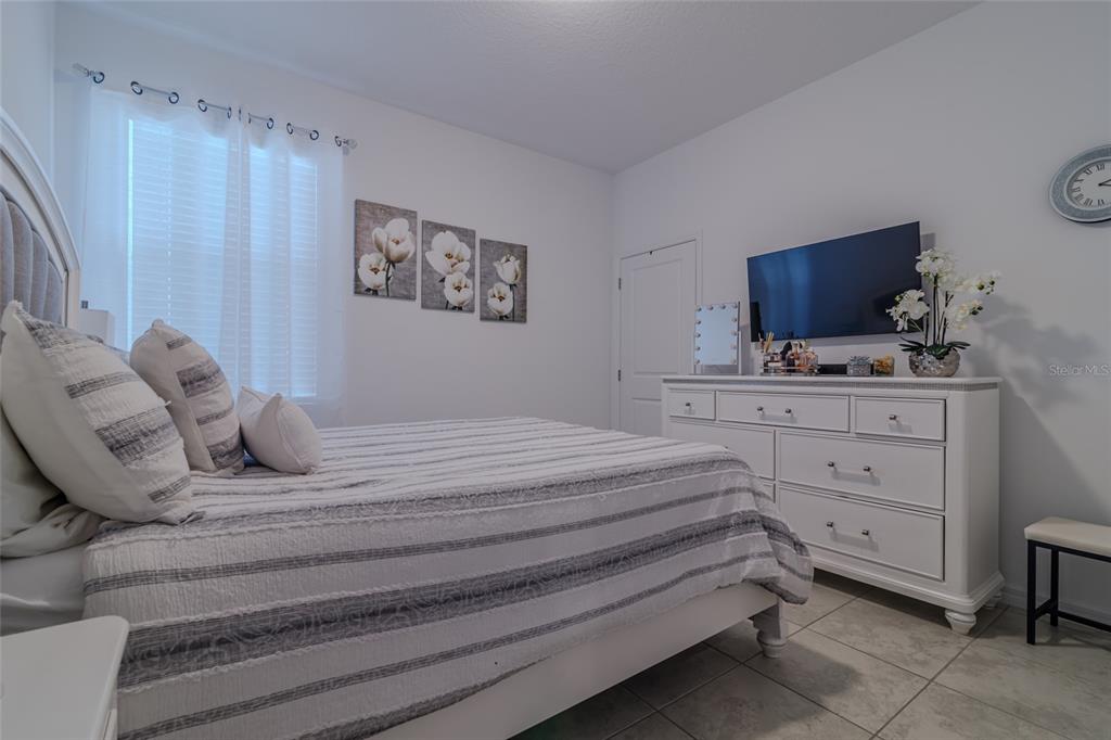 7095 Southwest 61st Place Ocala, FL 34474 - Photo 45 of 61 a bedroom with a bed and a television