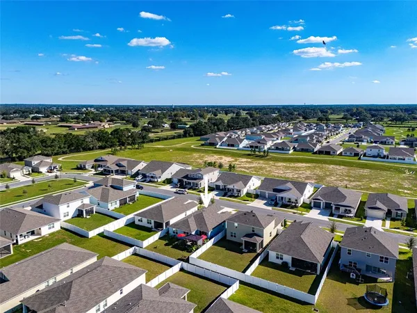 a view of swimming pool with outdoor seating a yard and ocean view