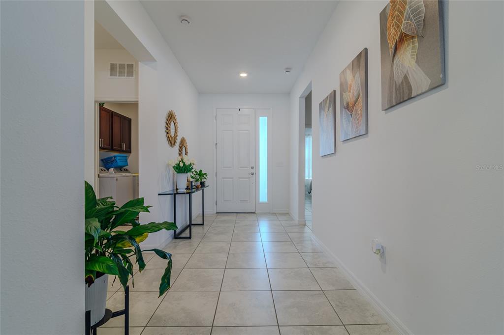 7095 Southwest 61st Place Ocala, FL 34474 - Photo 8 of 61 a hallway with a potted plant on the wall and a window