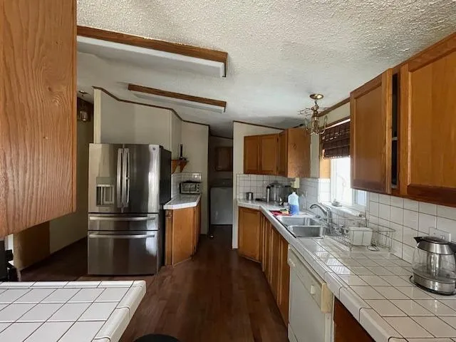 a kitchen with a refrigerator stove and microwave