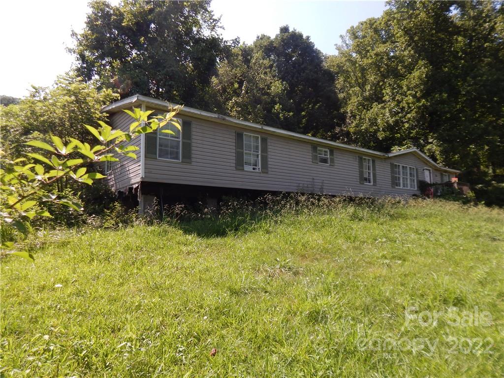 124 Oconeechee Road Clyde, NC 28721 - Photo 11 of 14 a house with trees in the background