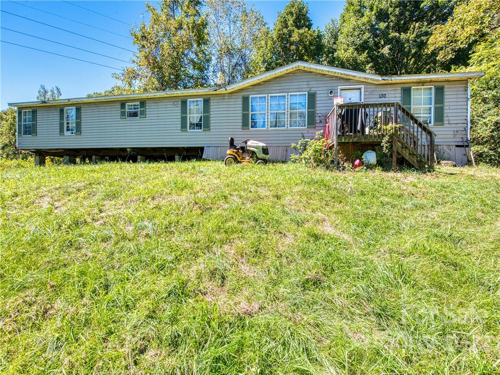 124 Oconeechee Road Clyde, NC 28721 - Photo 2 of 14 a front view of a house with garden