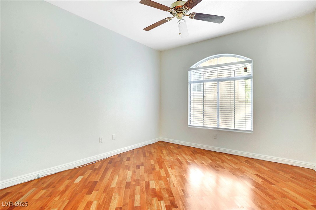 8725 Red Rio Drive, Unit 203 Las Vegas, NV 89128 - Photo 17 of 38 Spare room featuring light wood-style flooring, baseboards, and a ceiling fan