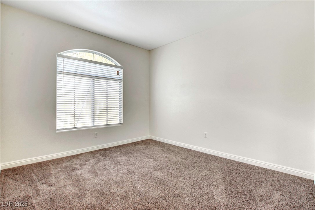 8725 Red Rio Drive, Unit 203 Las Vegas, NV 89128 - Photo 20 of 38 Carpeted spare room with baseboards