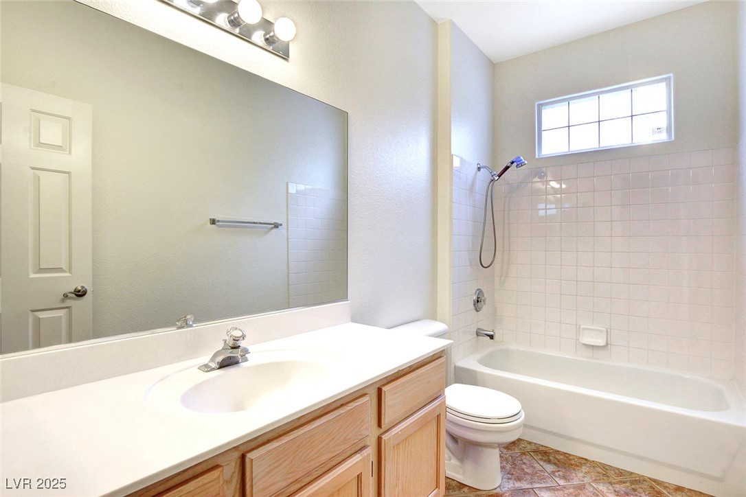 8725 Red Rio Drive, Unit 203 Las Vegas, NV 89128 - Photo 23 of 38 Full bath featuring toilet, vanity, tub / shower combination, and tile patterned flooring