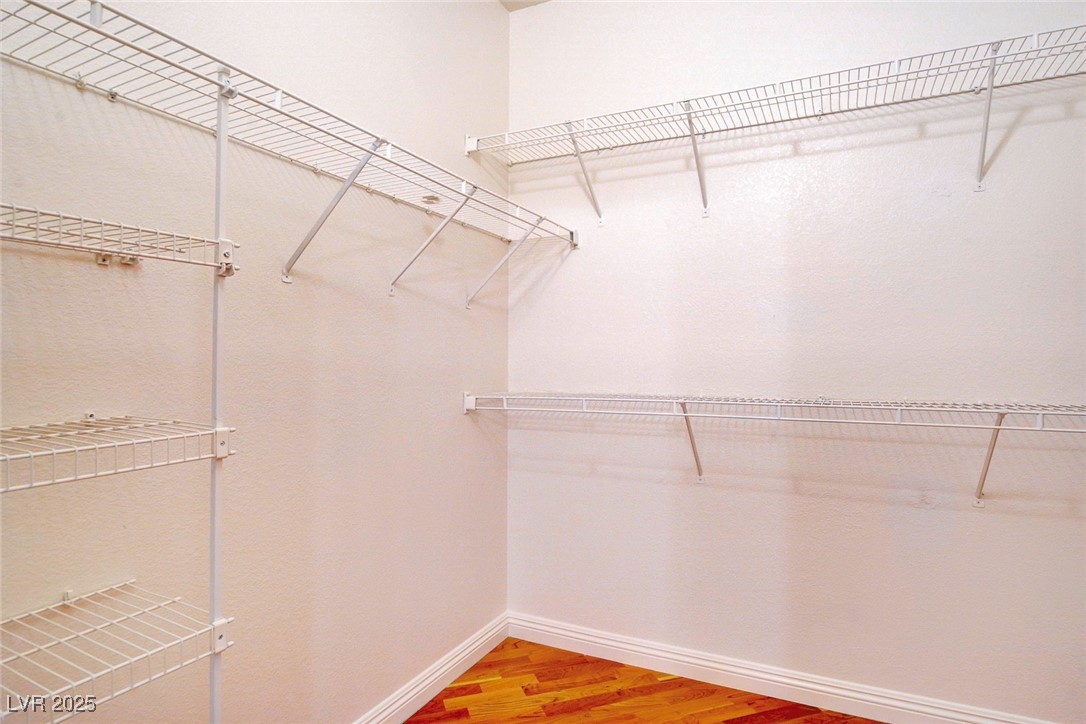 8725 Red Rio Drive, Unit 203 Las Vegas, NV 89128 - Photo 27 of 38 Walk in closet featuring light wood-type flooring
