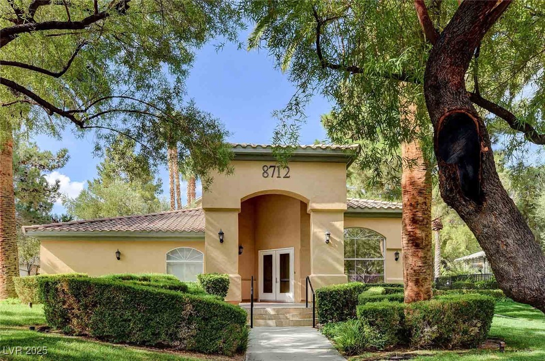 8725 Red Rio Drive, Unit 203 Las Vegas, NV 89128 - Photo 34 of 38 View of front facade with french doors, a tile roof, and stucco siding