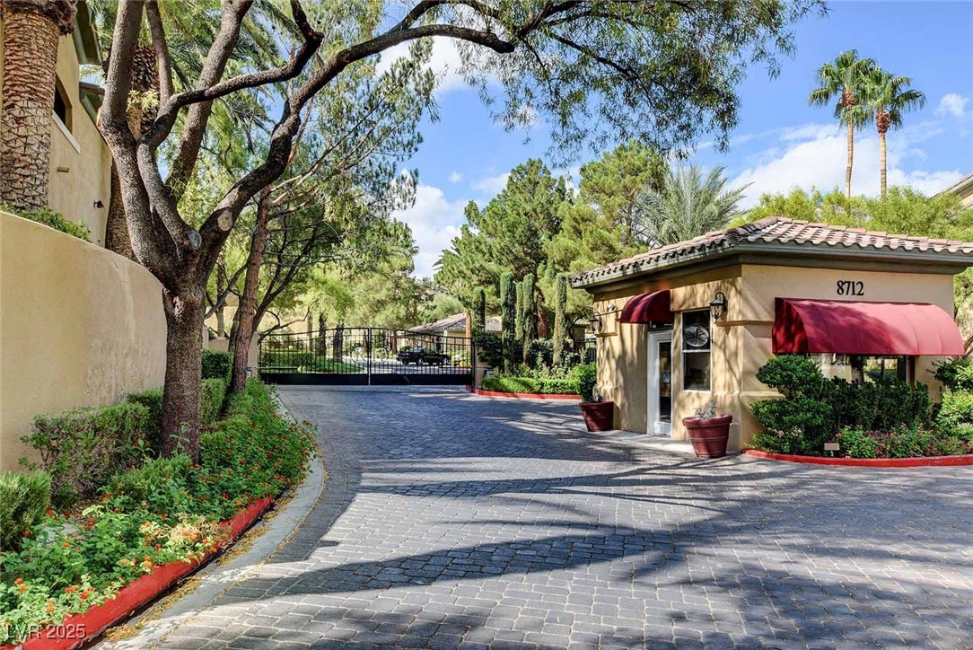 8725 Red Rio Drive, Unit 203 Las Vegas, NV 89128 - Photo 38 of 38 View of street featuring a gate and curbs