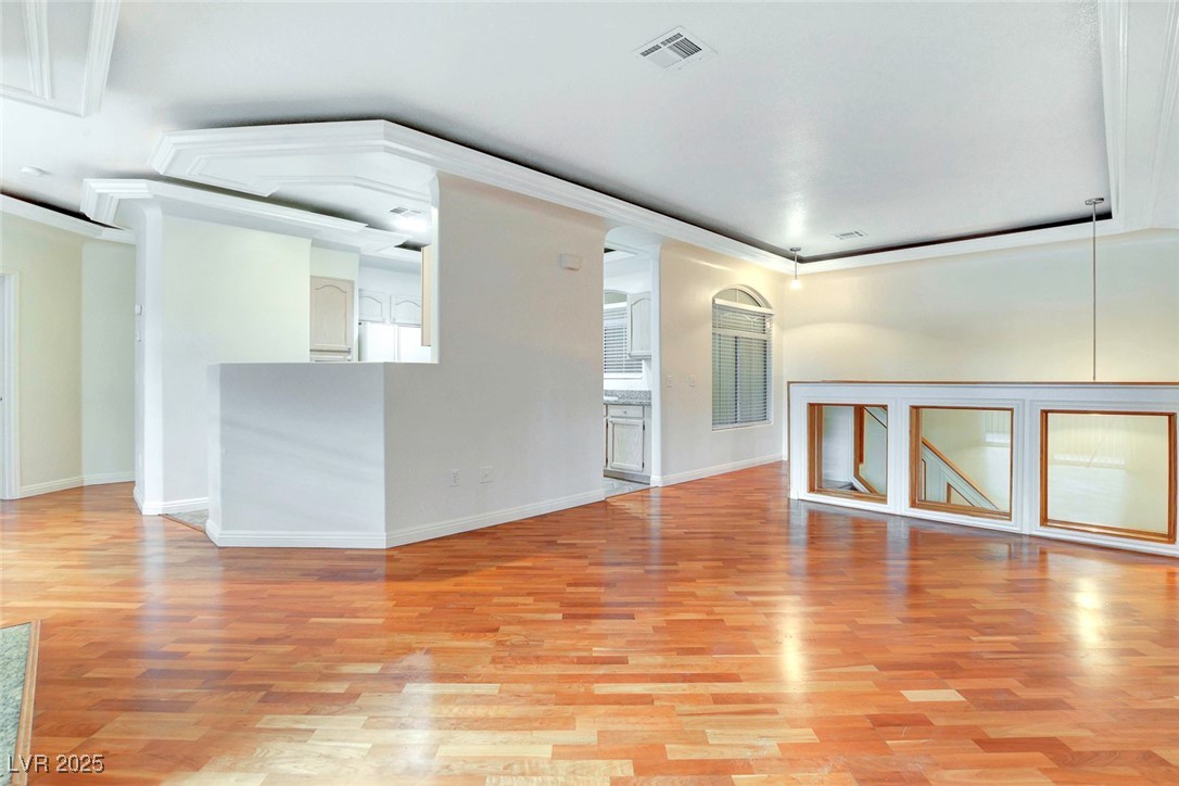 8725 Red Rio Drive, Unit 203 Las Vegas, NV 89128 - Photo 5 of 38 Unfurnished living room with light wood-style floors and baseboards
