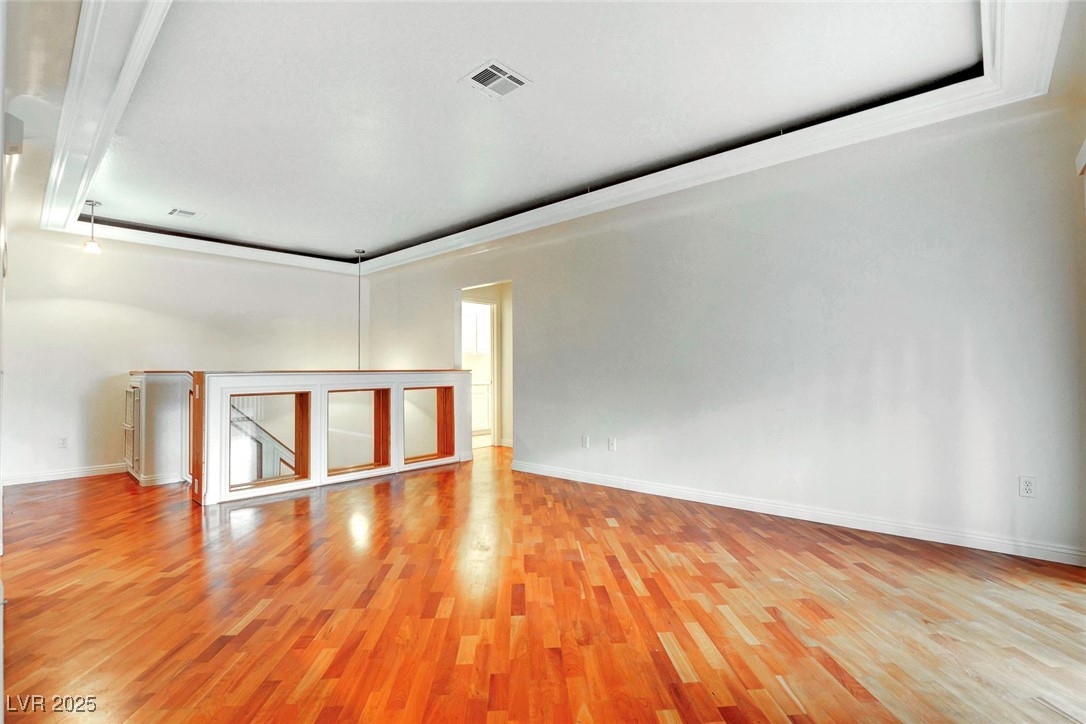 8725 Red Rio Drive, Unit 203 Las Vegas, NV 89128 - Photo 6 of 38 Spare room featuring light wood-style floors and baseboards