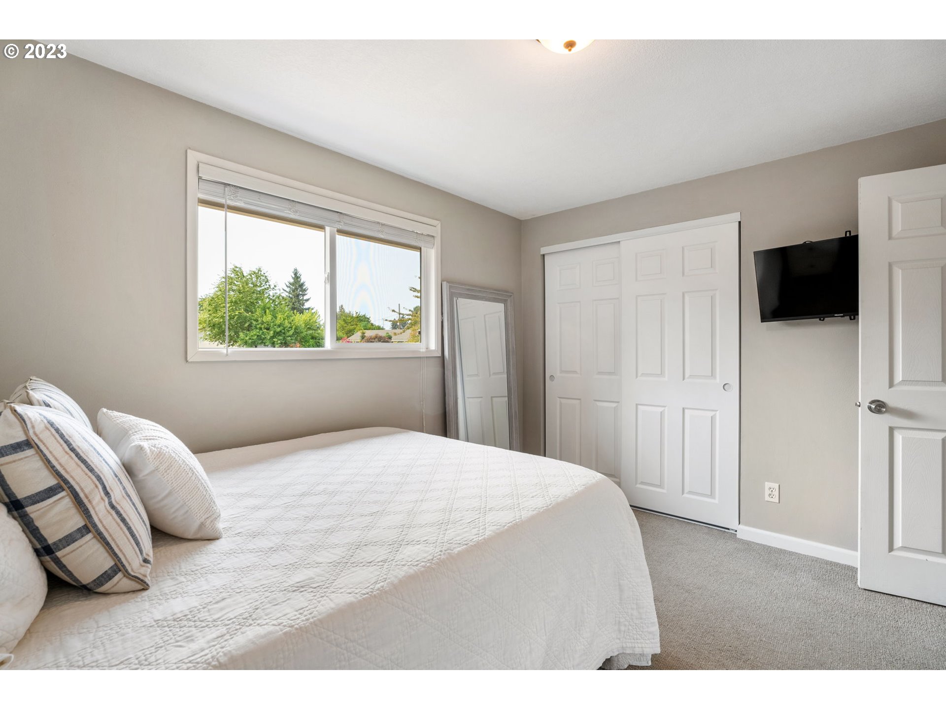 326 Southeast 236th Court Gresham, OR 97030 - Photo 18 of 34 a bedroom with a bed and a flat screen tv