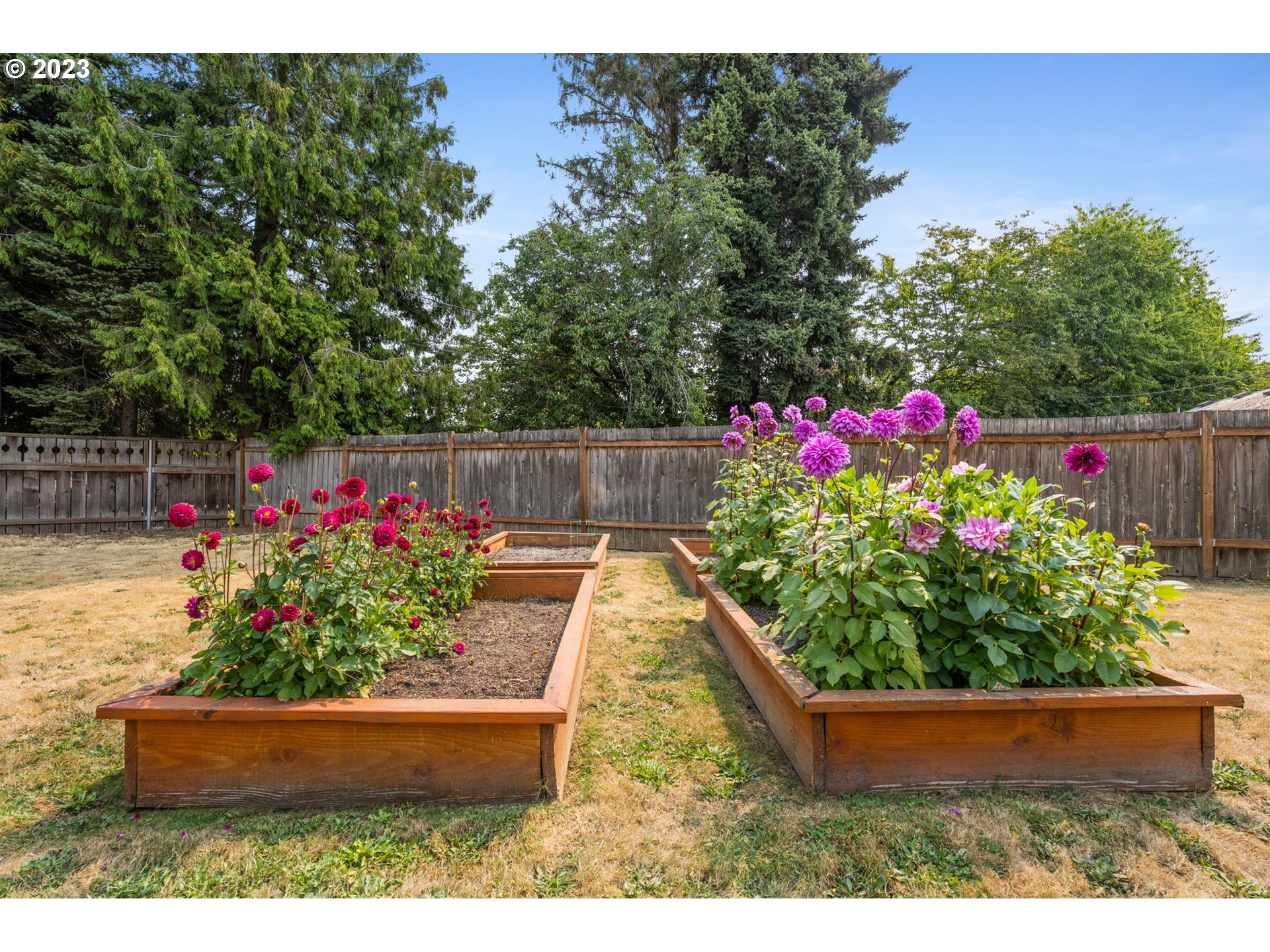 326 Southeast 236th Court Gresham, OR 97030 - Photo 32 of 34 a view of a garden with flowers and a bench
