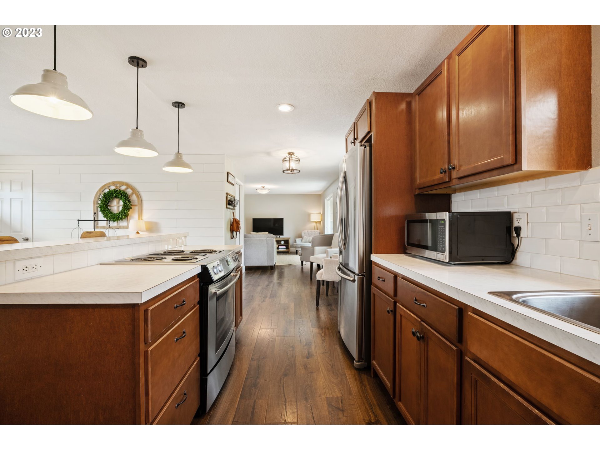 326 Southeast 236th Court Gresham, OR 97030 - Photo 10 of 34 a kitchen with a stove a refrigerator and a sink