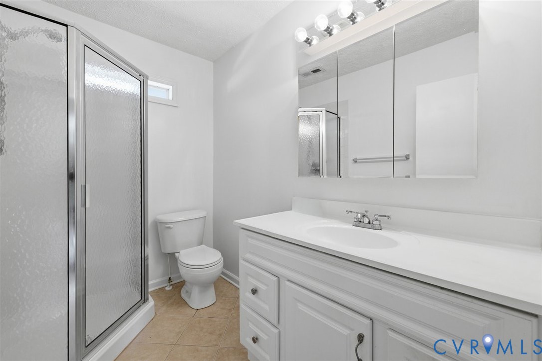 18501 Branders Bridge Road Colonial Heights, VA 23834 - Photo 17 of 43 a bathroom with a sink a toilet a large mirror and shower