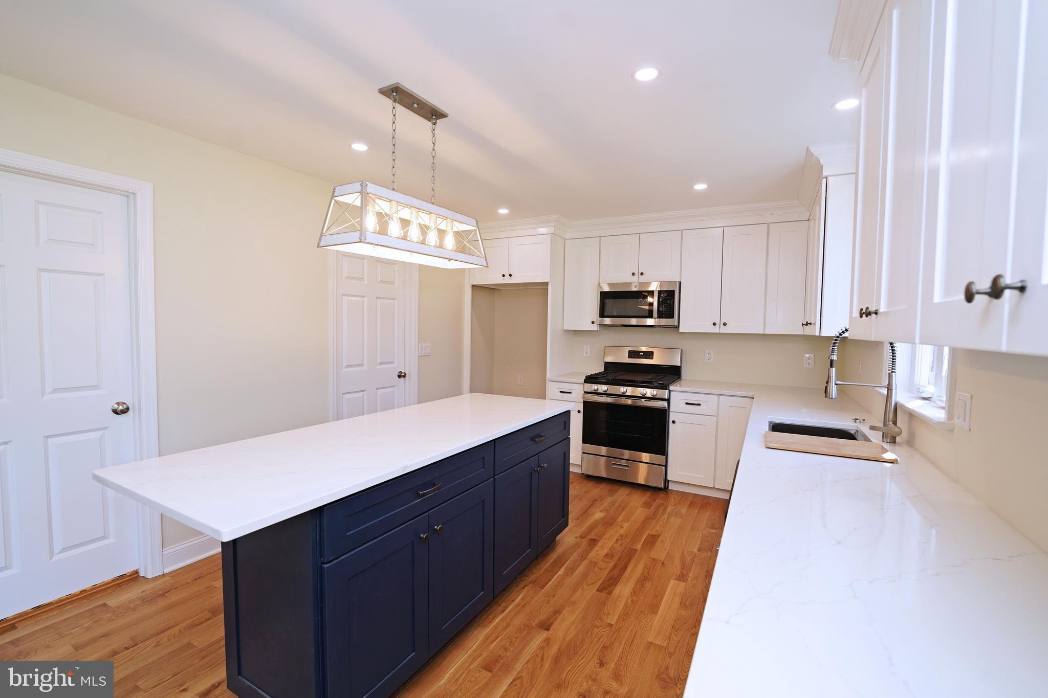 1341 Lower Ferry Road Ewing, NJ 08618 - Photo 14 of 39 a kitchen with kitchen island granite countertop stainless steel appliances cabinets a sink and a counter top space