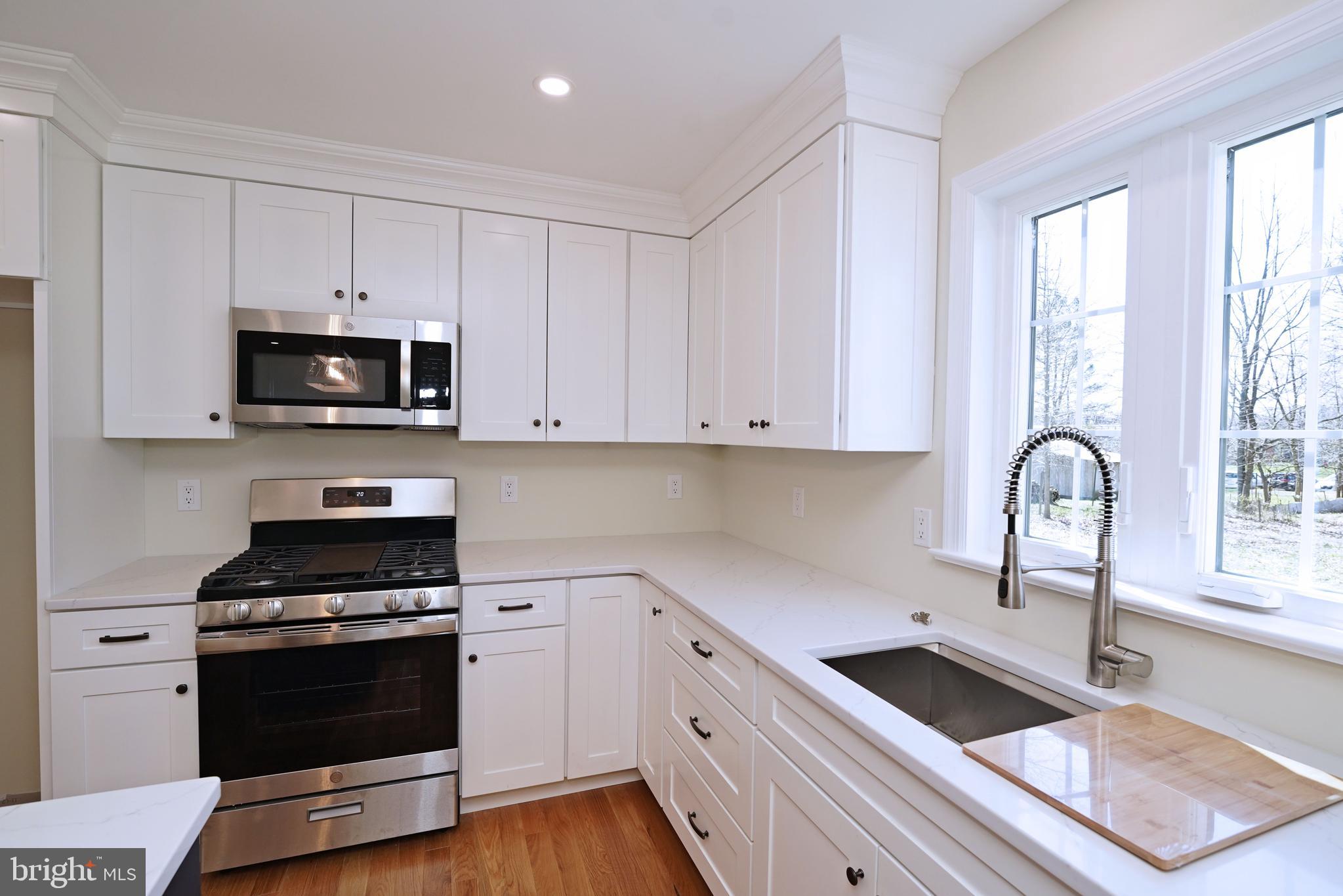 1341 Lower Ferry Road Ewing, NJ 08618 - Photo 15 of 39 a kitchen with granite countertop a stove a sink and a microwave