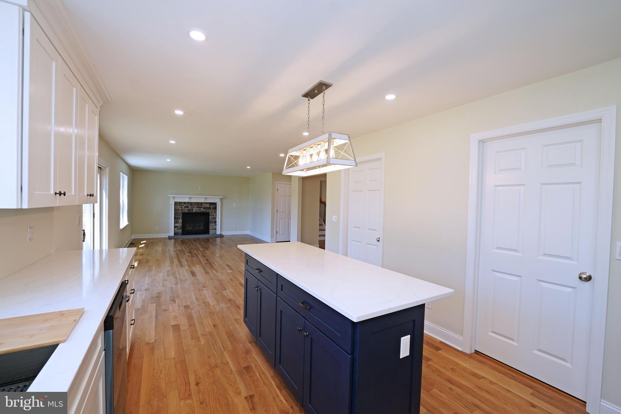 1341 Lower Ferry Road Ewing, NJ 08618 - Photo 16 of 39 a open kitchen with kitchen island a stove a sink dishwasher and a refrigerator with wooden floor