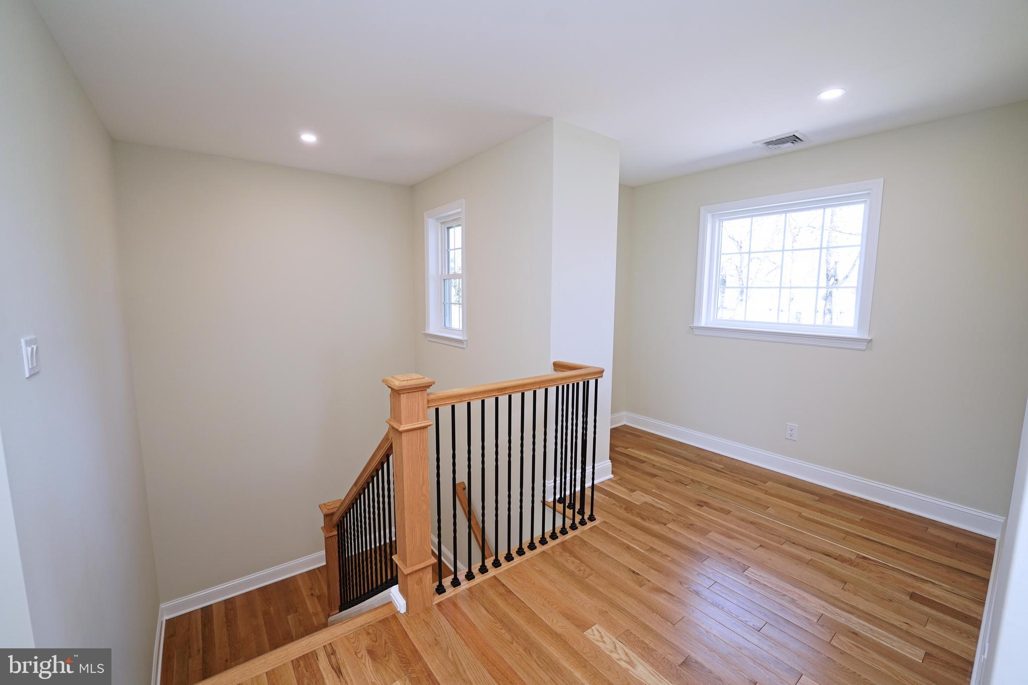 1341 Lower Ferry Road Ewing, NJ 08618 - Photo 20 of 39 an empty room with wooden floor and windows