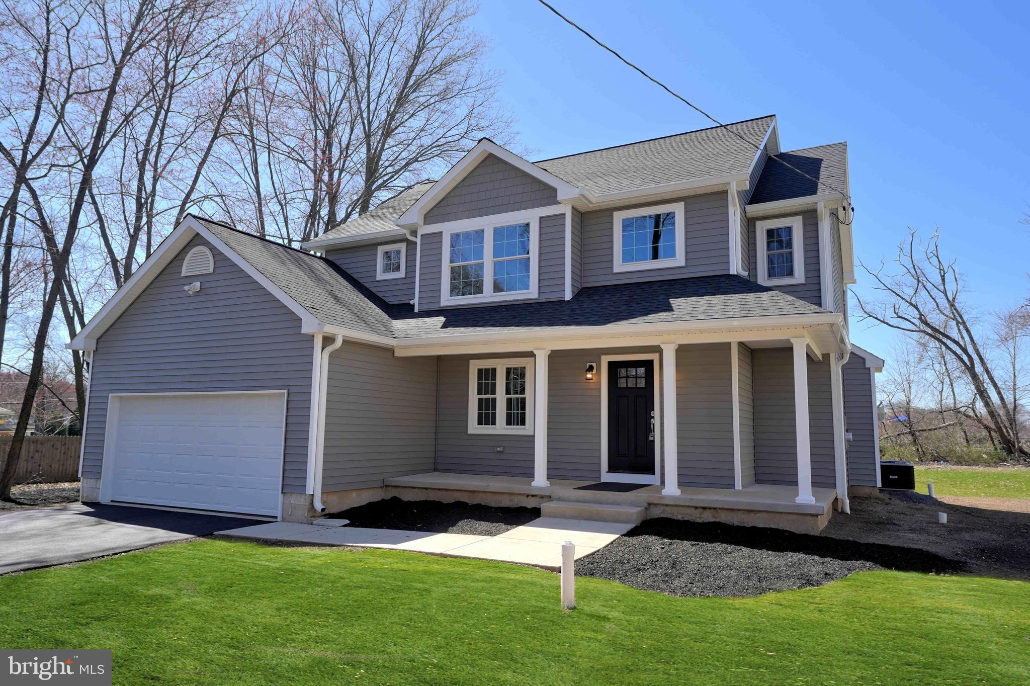 1341 Lower Ferry Road Ewing, NJ 08618 - Photo 2 of 39 a front view of a house with a yard and garage