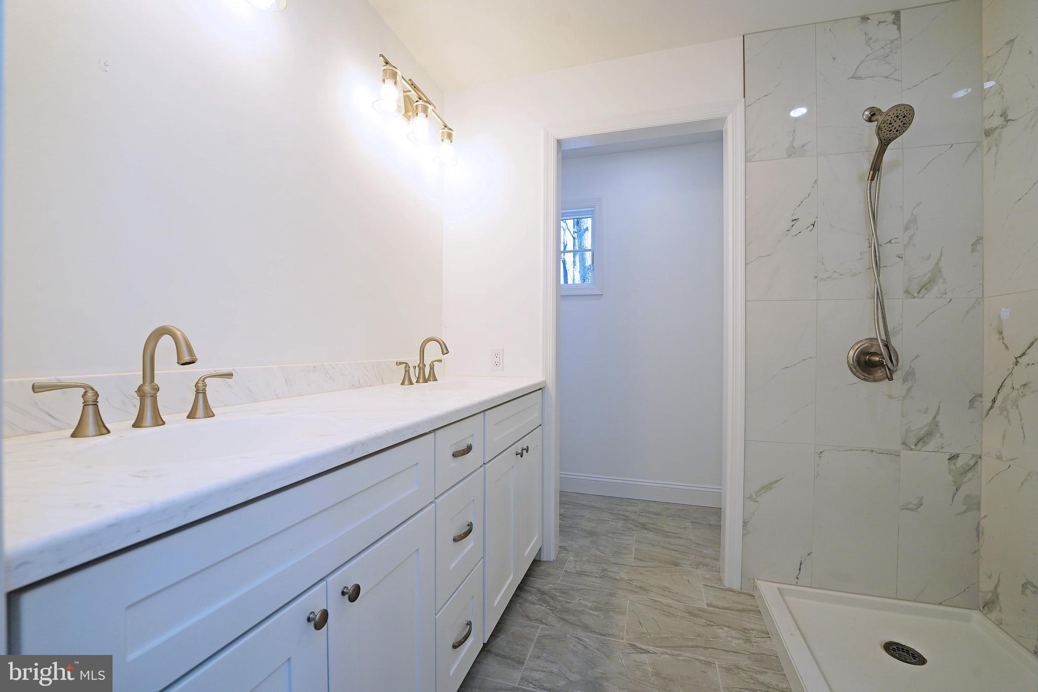 1341 Lower Ferry Road Ewing, NJ 08618 - Photo 23 of 39 a bathroom with a double vanity sink a toilet and shower