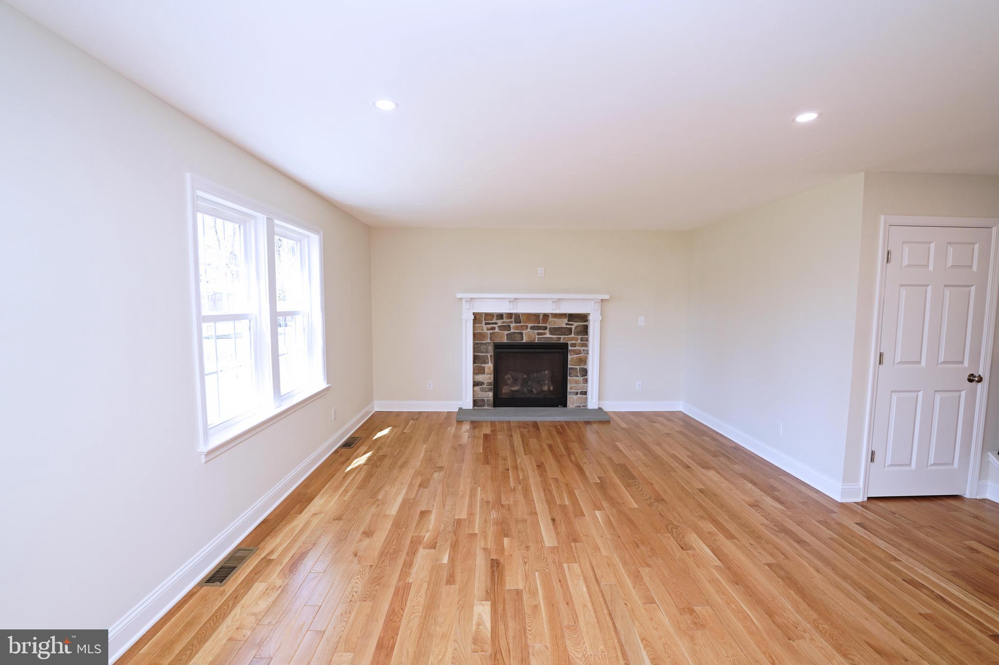 1341 Lower Ferry Road Ewing, NJ 08618 - Photo 8 of 39 a view of empty room with wooden floor and fireplace