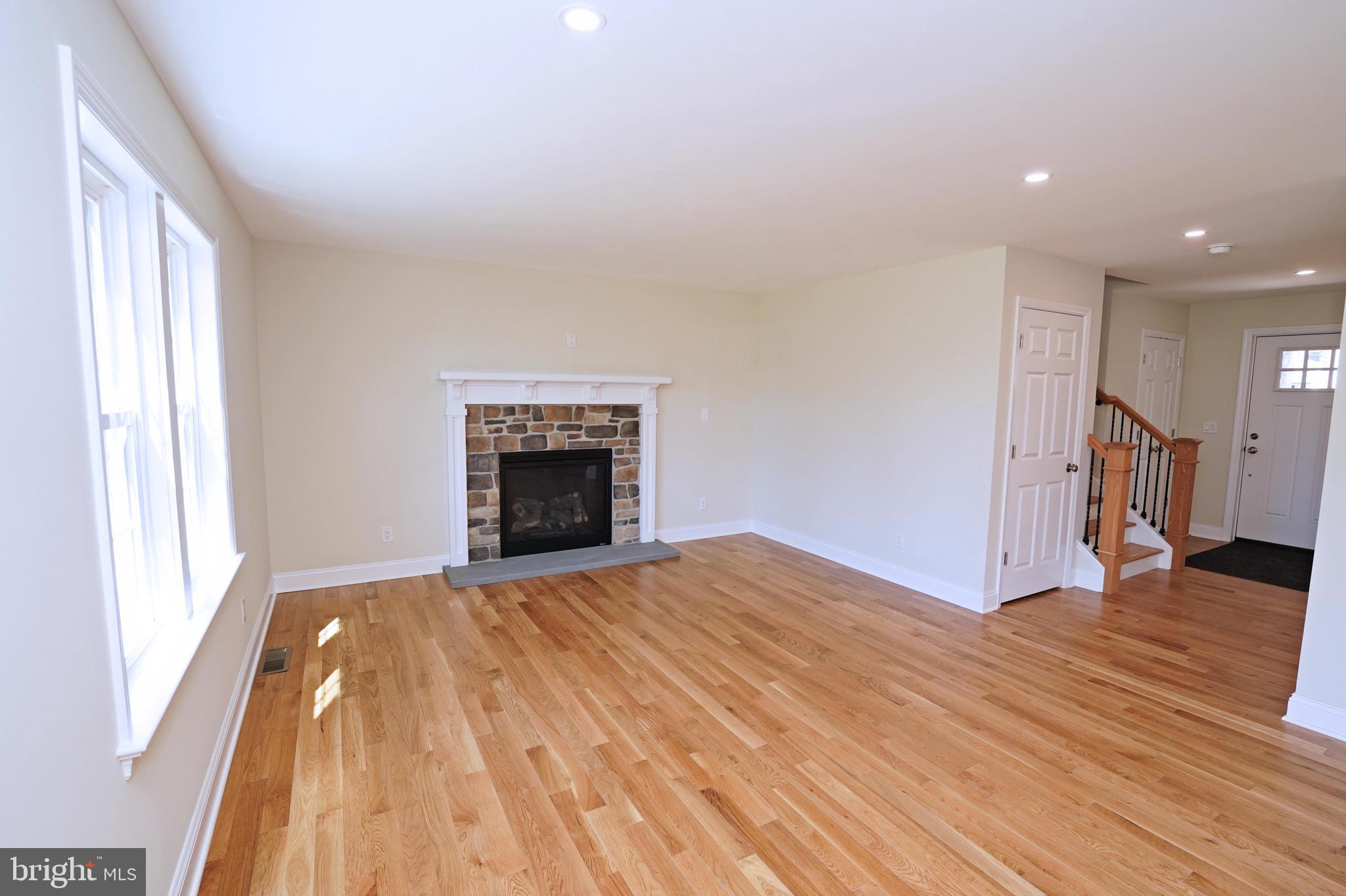 1341 Lower Ferry Road Ewing, NJ 08618 - Photo 9 of 39 a view of empty room with wooden floor and fireplace
