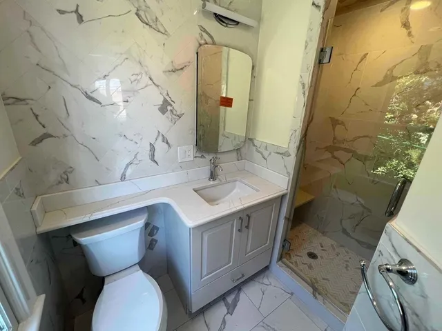 a bathroom with a sink toilet and shower