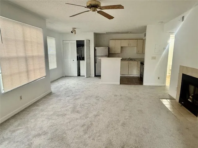 a view of a livingroom with a fireplace a sink and a stove top oven