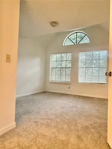 an empty room with a empty space and windows