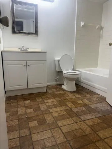 a bathroom with a sink a toilet and mirror