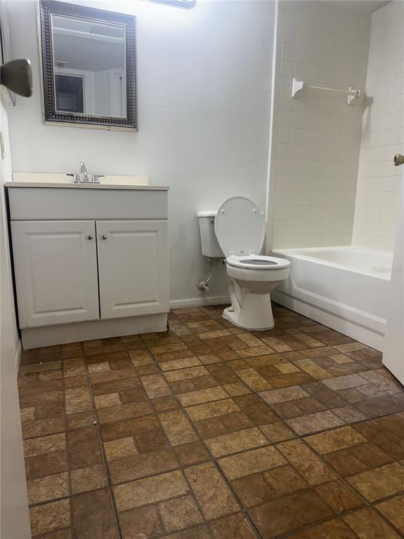 365 Forestway Circle, Unit 101 Altamonte Springs, FL 32701 - Photo 10 of 16 a bathroom with a sink a toilet and mirror