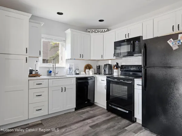 a kitchen with a refrigerator stove and sink
