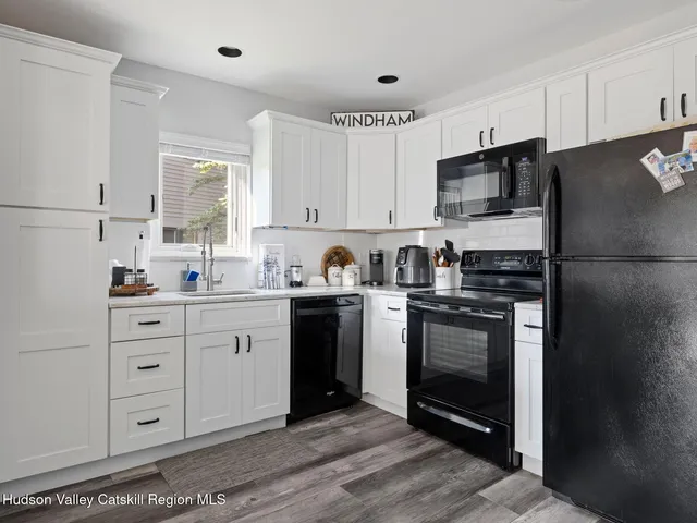a kitchen with a refrigerator stove and sink