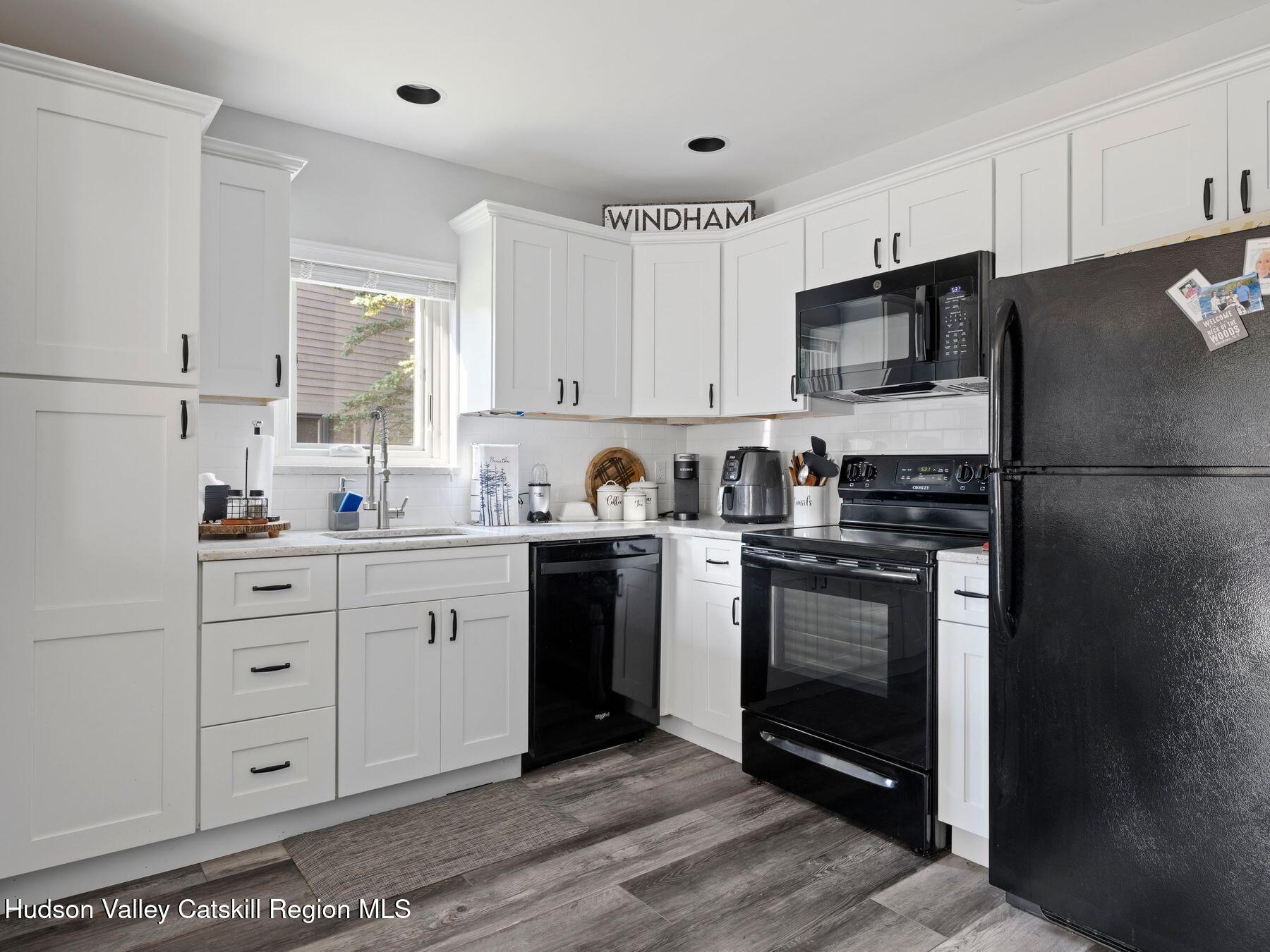73 Windham Ridge Road, Unit 16H Windham, NY 12496 - Photo 11 of 36 a kitchen with a refrigerator stove and sink