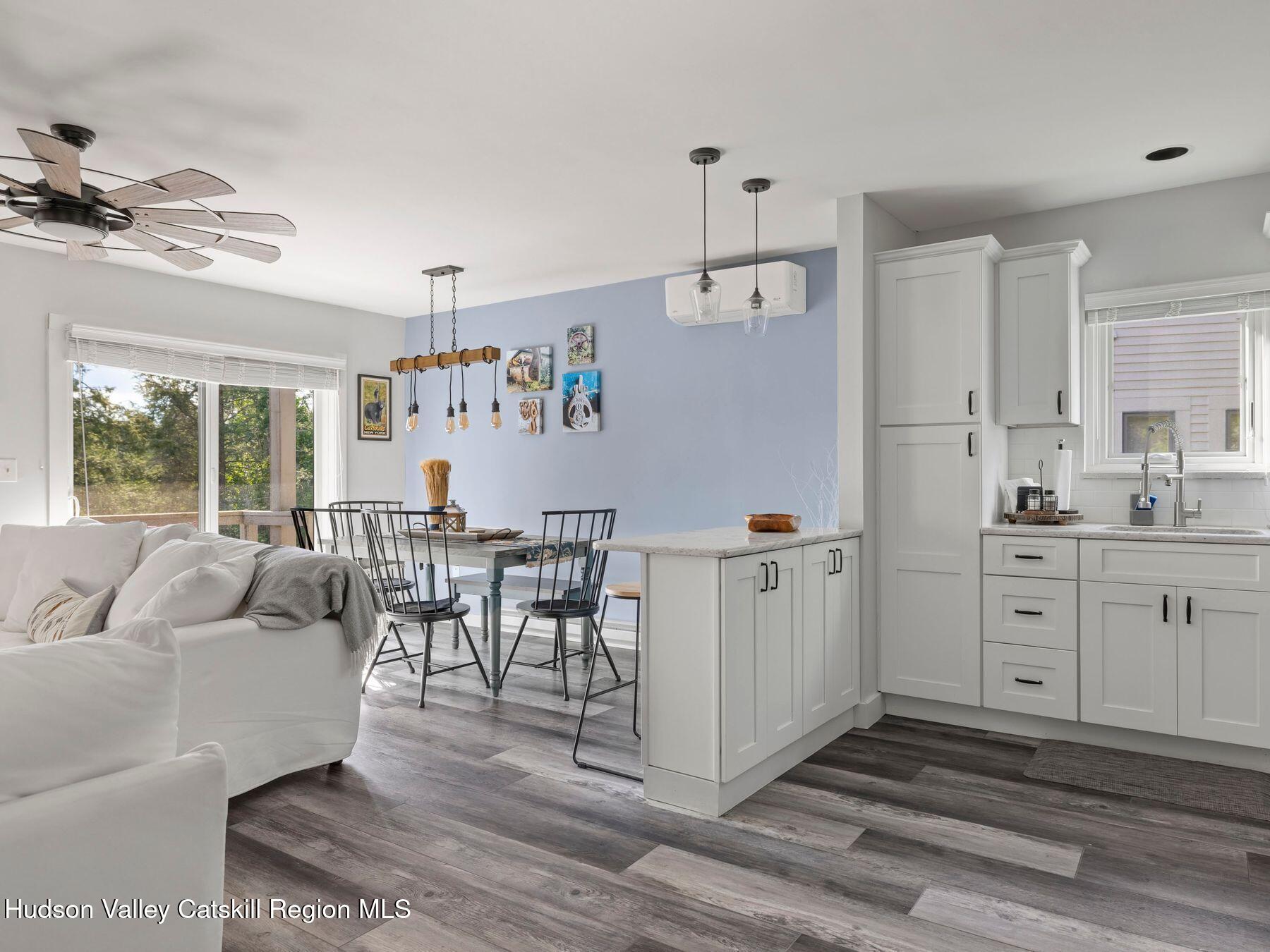 73 Windham Ridge Road, Unit 16H Windham, NY 12496 - Photo 12 of 36 a living room with furniture and a large window