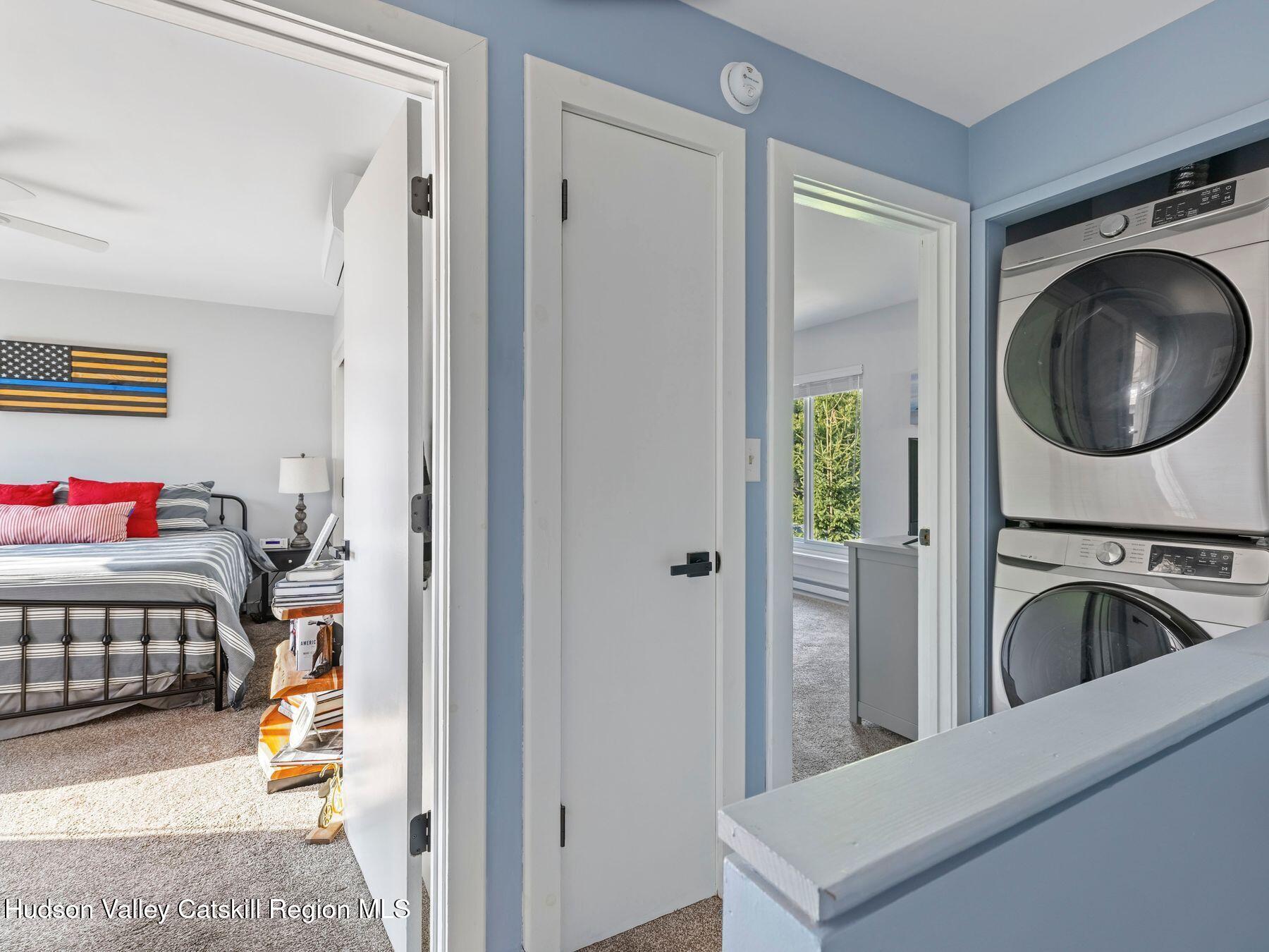 73 Windham Ridge Road, Unit 16H Windham, NY 12496 - Photo 13 of 36 a view of a bedroom and bedroom washer and dryer