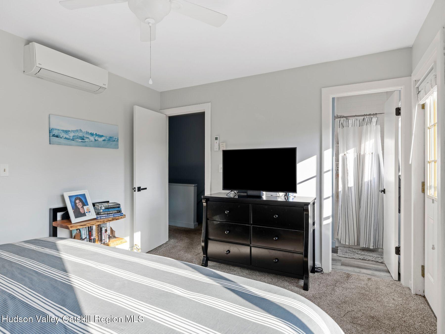 73 Windham Ridge Road, Unit 16H Windham, NY 12496 - Photo 15 of 36 a bedroom with a bed and a flat screen tv