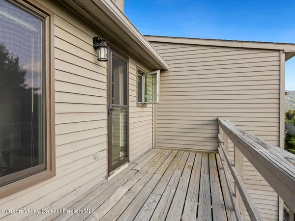 a roof deck with a table and chairs