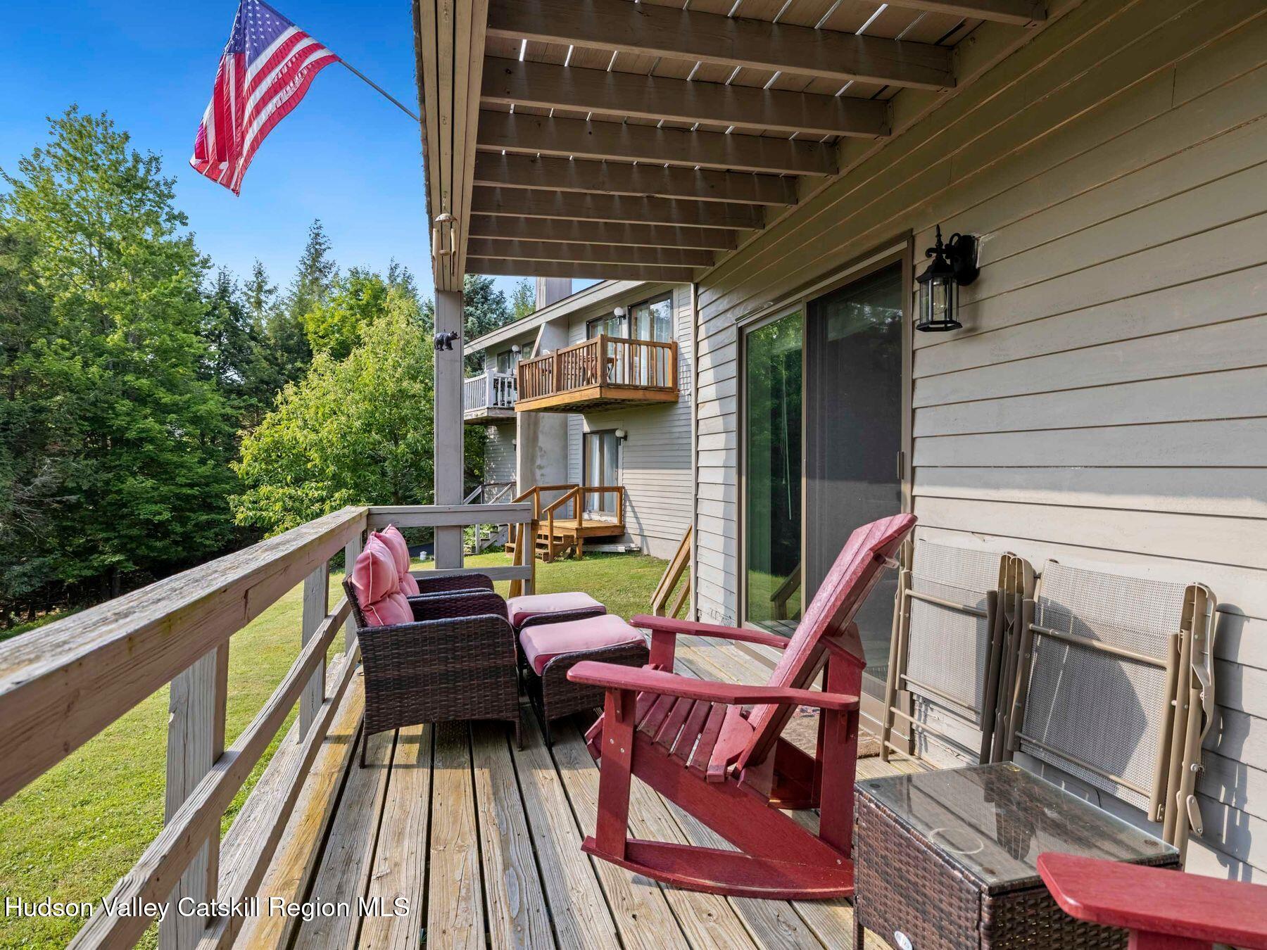 73 Windham Ridge Road, Unit 16H Windham, NY 12496 - Photo 28 of 36 a view of deck with chairs and wooden fence