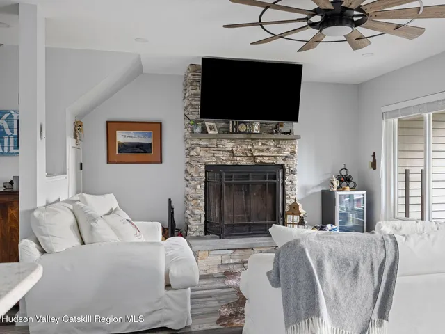 a living room with furniture a fireplace and a flat screen tv