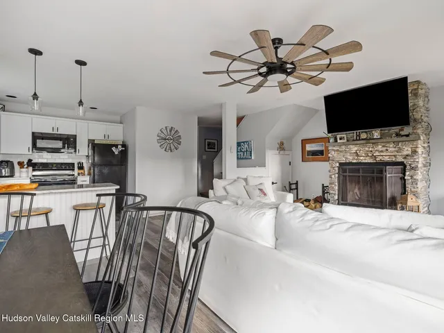 a view of a livingroom with furniture a flat screen tv and a fireplace
