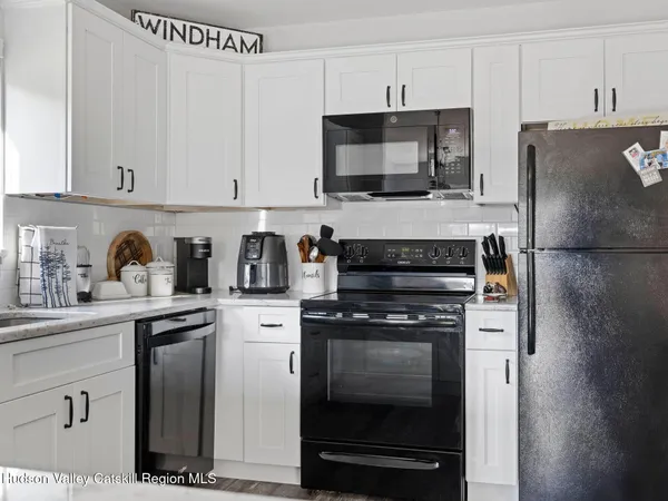 a kitchen with cabinets stainless steel appliances and a counter space