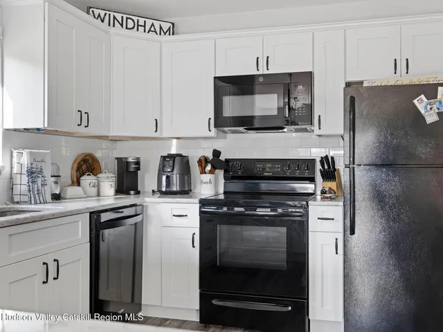 a kitchen with cabinets stainless steel appliances and a counter space
