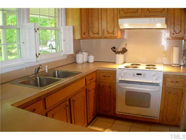 8805 Red Oak Court Raleigh, NC 27613 - Photo 4 of 12 Well laid out kitchen has tile floor, a Brand new energy efficient dishwasher, loads of cabinet and counter space, a pantry and is convenient to both breakfast room and dining room. Kitchen