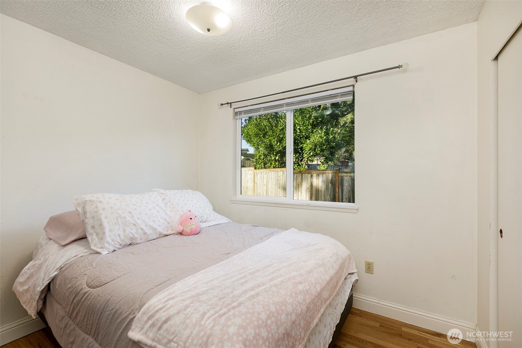 4003 Northeast 6th Court Renton, WA 98056 - Photo 15 of 20 a bedroom with a bed and a window