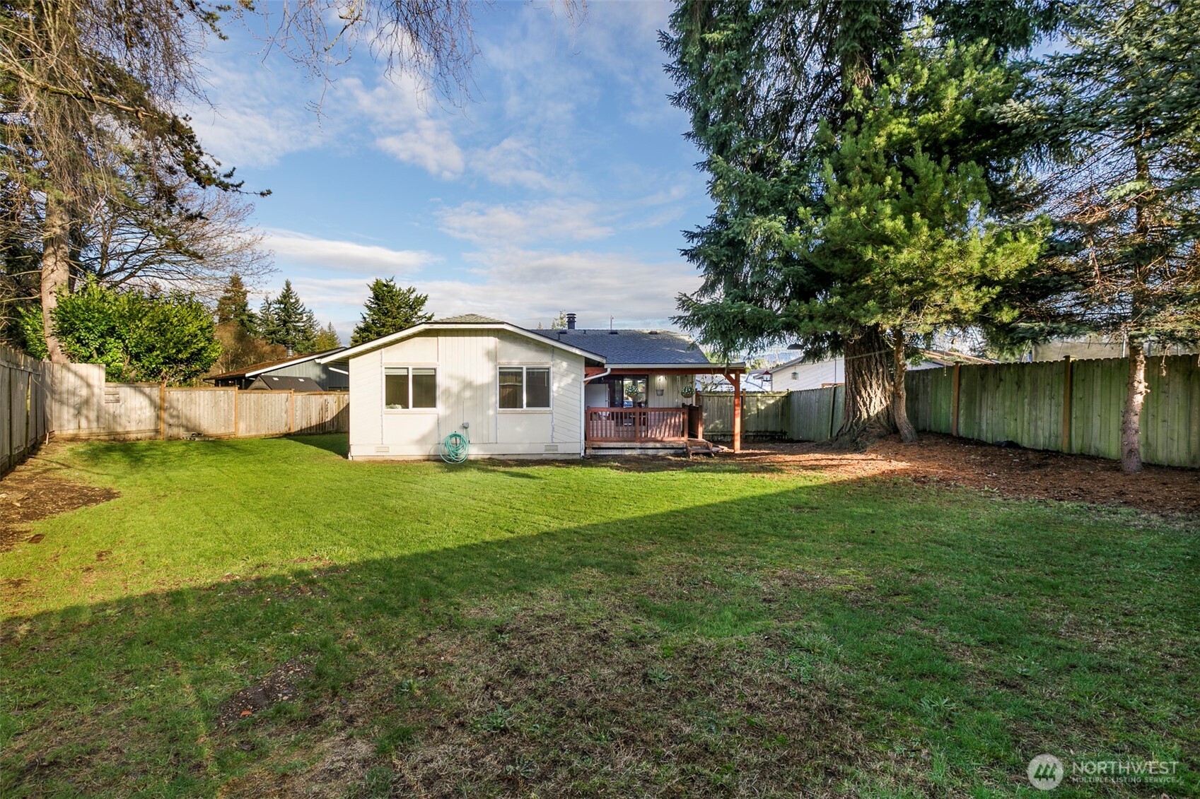 4003 Northeast 6th Court Renton, WA 98056 - Photo 17 of 20 a view of a house with backyard and sitting area