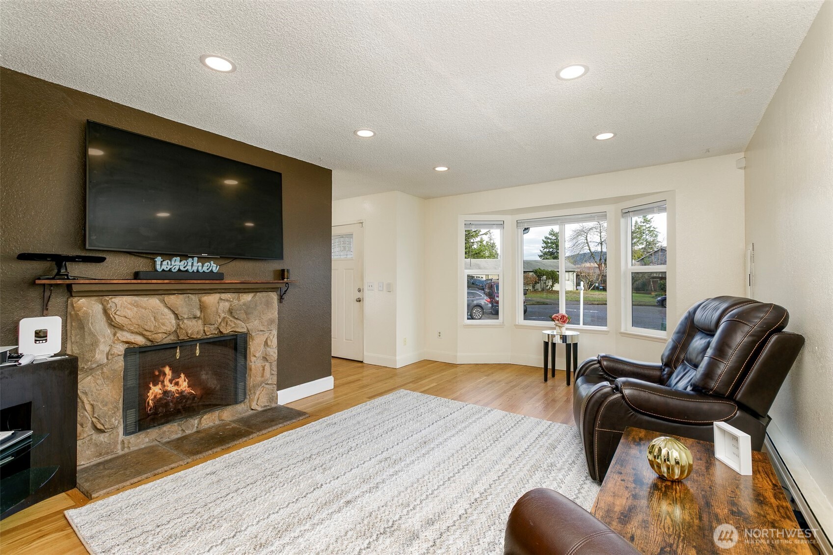 4003 Northeast 6th Court Renton, WA 98056 - Photo 2 of 20 a living room with furniture and a flat screen tv